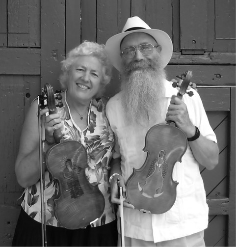 Ken Keppeler & Jeanine McLerie proudly displaying their engraved well used fiddles 