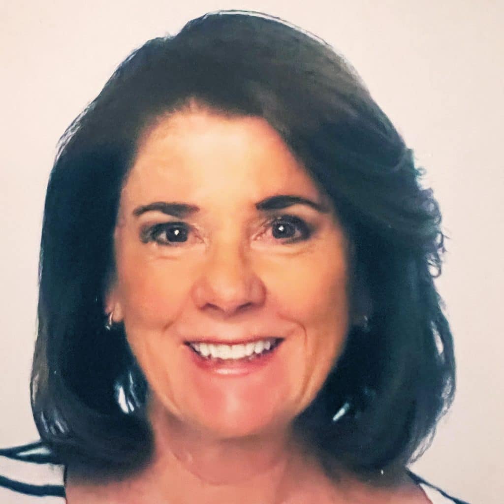 A woman with brown hair and a striped shirt.