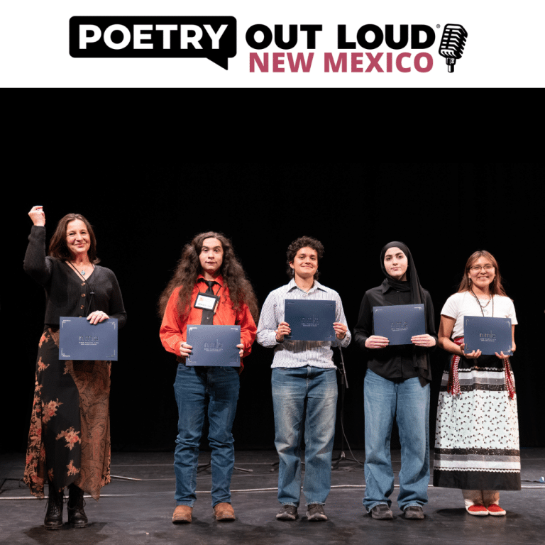 A group of 4 teenagers receiving an award on a stage with an advisor,