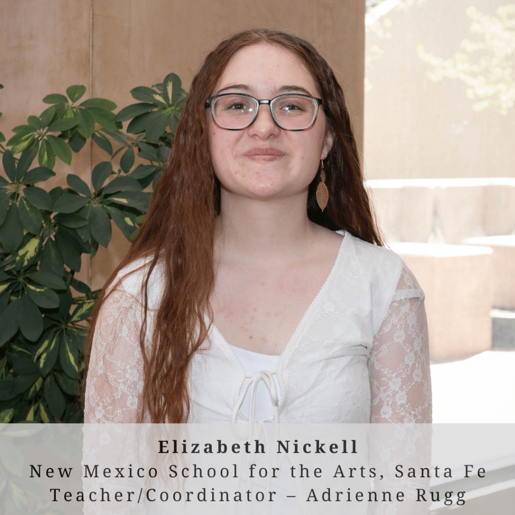 A young woman with long red hair wearing glasses