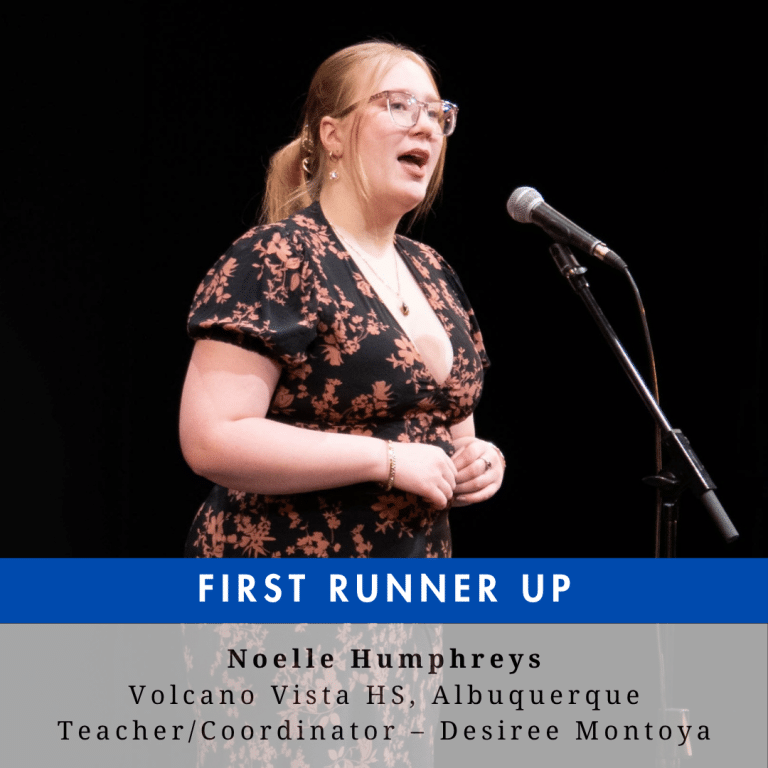 A young woman with blonde hair and glasses on a stage