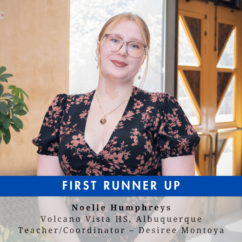 A young woman with light colored hair pulled back in a ponytail wearing glasses