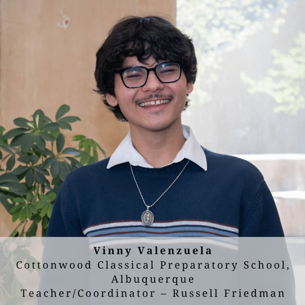 A young man with glasses and bushy brown hair